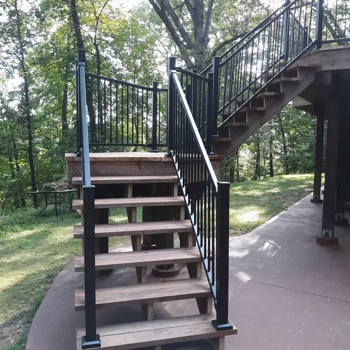Deck stairs with landing and black metal railings