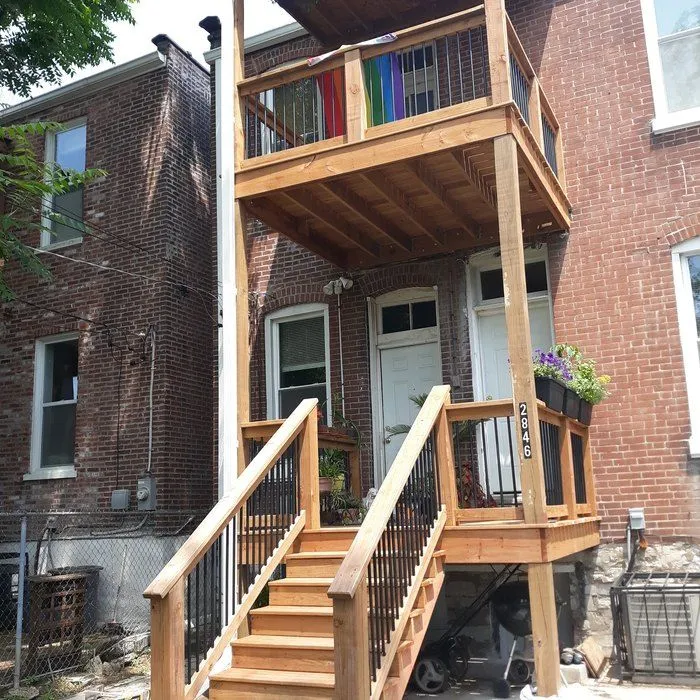 Two-story deck and staircase on a brick rowhouse